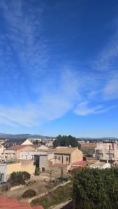 a view of a city with a blue sky at El bon repòs del delta in El Lligallo del Gànguil
