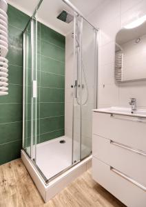 a bathroom with a shower and a sink at Platinium Zaspa - Pilotów 14 in Gdańsk
