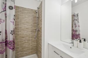 a bathroom with a shower and a toilet and a sink at Chic and spacious apart with parking in Cergy +12 photos