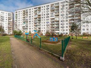 a playground in a park in front of a building at Platinium Zaspa - Pilotów 14 in Gdańsk