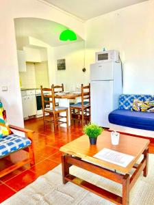 a living room with a couch and a table at Resort Albufeira T1, Praia da Oura in Albufeira