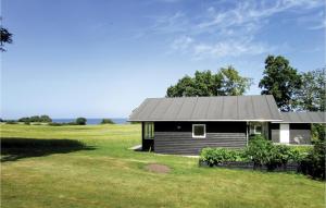 a small house in the middle of a field at Three-Bedroom Holiday Home In Augustenborg in Augustenborg