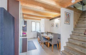a dining room with a table and chairs and a staircase at 3 Bedroom Nice Home In Lazise Vr in Lazise