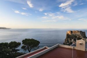 a view of the ocean and a castle at Casa Santacroce in Scilla