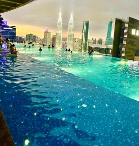 a swimming pool with a city skyline in the background at Eaton Service Apartment at KLCC in Kuala Lumpur