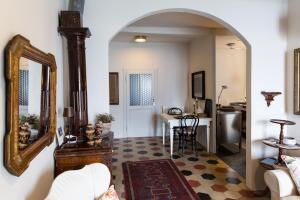 a living room with a mirror and a table at Varenna Caffè Apartment in Varenna