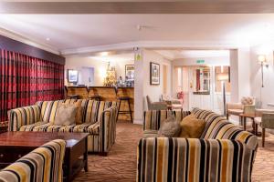 a living room with couches and a bar at Three Ways House Hotel in Chipping Campden