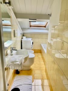 a bathroom with two toilets and a sink at Delizioso appartamento in centro! in Fano