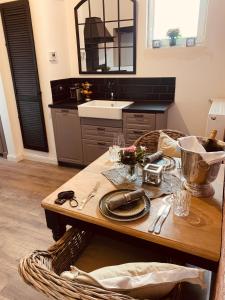 a kitchen with a wooden table and a sink at The Hampton Hock's - Wellness & Wine in Freinsheim