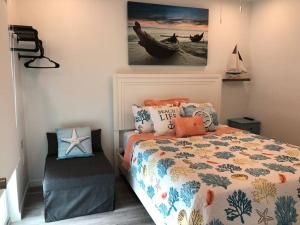 a bedroom with a bed and a boat on the wall at THE SANDCASTLE SUITE! Brand New 2Bedroom in Oceanfront Complex! BE THE FIRST to Visit our Condo Townhome with FREE Parking & Private Garage at Ocean Isles 38 Marathon FL KEYS! SPECIAL PRICING!!! in Marathon +112 photos