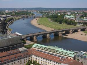 a bridge over a river next to a city at City Apart Dresden Apartment 4 in Dresden