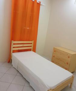 a small bedroom with a bed and a dresser at L2B - São Vicente in Mindelo