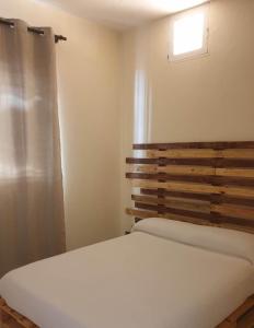 a bedroom with a white bed and a window at L2B - São Vicente in Mindelo