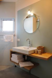 a bathroom with a sink and a mirror and towels at Hoeve H-art, Silo 161, Uniek Drents silo-appartement met privé terras en rust in Ruinerwold +63 photos