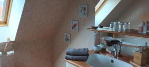 a bathroom with a sink and a mirror at La Maison des Poulains in Sauzon