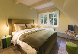 a bedroom with a large bed and a window at Das Landhaus in Bilsen
