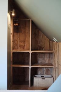 a room with wooden shelves in a attic at Penthouse : immersion dans la nature in Durbuy