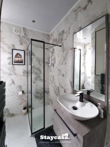 a white bathroom with a sink and a shower at Spacious 6-bed With Large Patio And Free Parking in Manchester