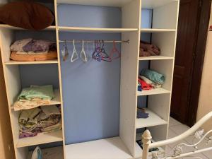 a walk in closet with white shelving at Domaine de kanelle in Rivière-Pilote