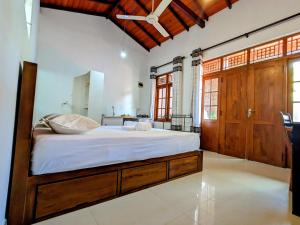 a bedroom with a large bed with white sheets at Lavish Lodge, Tangalle, Sri Lanka in Tangalle