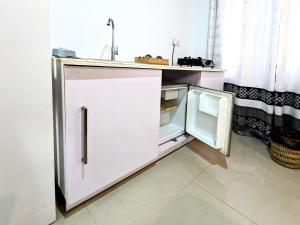 a kitchen with an open refrigerator and a sink at Lavish Lodge, Tangalle, Sri Lanka in Tangalle