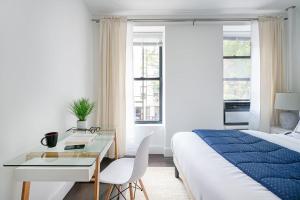 a bedroom with a bed and a table and a desk at 444-4F Newly renovated 1BR in Midtown West in New York
