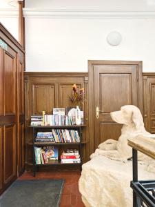 a bedroom with a bed and a book shelf with books at Residence Charles Bridge in Prague