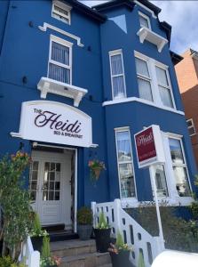 a blue building with a hotel sign in front of it at The Heidi Bed & Breakfast in Southport