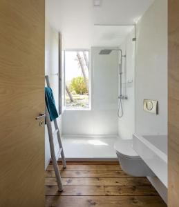 une salle de bain avec toilettes, lavabo et fenêtre dans l'établissement A Casa do Guincho, Beach House, à Areias