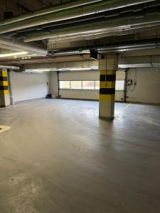 an empty parking garage with a large room with windows at Apartament City Warszawa in Warsaw