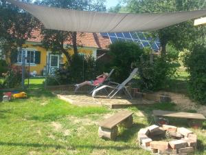 a woman sitting in a chair in a yard at Ferienhaus Planetz in Kaindorf