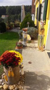 a garden with flowers in a pot next to a house at Ferienhaus Planetz in Kaindorf