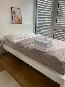 a white bed with towels on it in a bedroom at Studio Apartment mit Stellplatz in Bielefeld