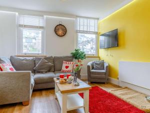 a living room with a couch and a table at 2 Bed in Brixham 54679 in Brixham