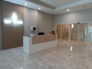 an office with a reception desk in a lobby at 19th Floor Secure Condo with Pool, Fitness, Parking Included in Price in Skopje