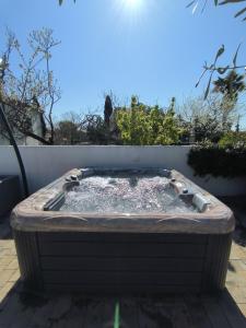 a hot tub sitting on a patio next to a fence at Apartmens Kimm II in Poreč