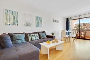 a living room with a couch and a table at Carihuela Playa by IVI Real Estate in Torremolinos