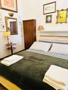 a bedroom with two beds with towels on them at Casa di Lo in Ciampino