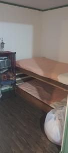 two bunk beds in a room with wood floors at La Cabaña del Bosque in Delicias