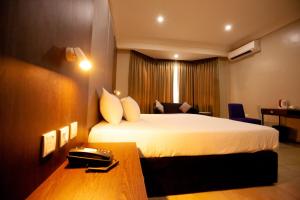 Voodi või voodid majutusasutuse Genesis Reventon Hotel toas