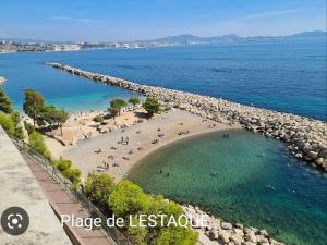 - une vue aérienne sur une plage avec des personnes dans l'eau dans l'établissement Charmant appartement proche de toutes commodités, à Marseille