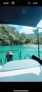 a boat in the water with a view of the ocean at Passeios jet home in Angra dos Reis