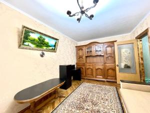 a living room with a bench and a chandelier at Premium new Apartament in Chişinău
