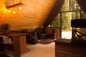 a living room with a couch and a fireplace at Chalé Anoitecer in Flores da Cunha