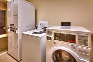 a kitchen with a washing machine and a refrigerator at Fairfield Inn & Suites Boise Nampa in Nampa