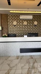 a reception counter in a hotel with a marble floor at NIYAMA LAND HOTEL in Umm Lujj