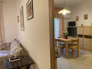 a bedroom with a table and a dining room at Giovanna in Rosolina Mare