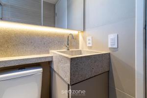a bathroom with a sink in a room at Excelente apt em Maceio/AL 850m da praia ADV306 in Maceió +9 photos