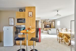 a kitchen and living room with a table and a dining room at Pointe de la Torche à 5km- Maison pour 4- Surf in Plomeur