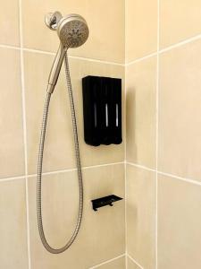 a shower with a shower head in a bathroom at Country Welcome in Micanopy